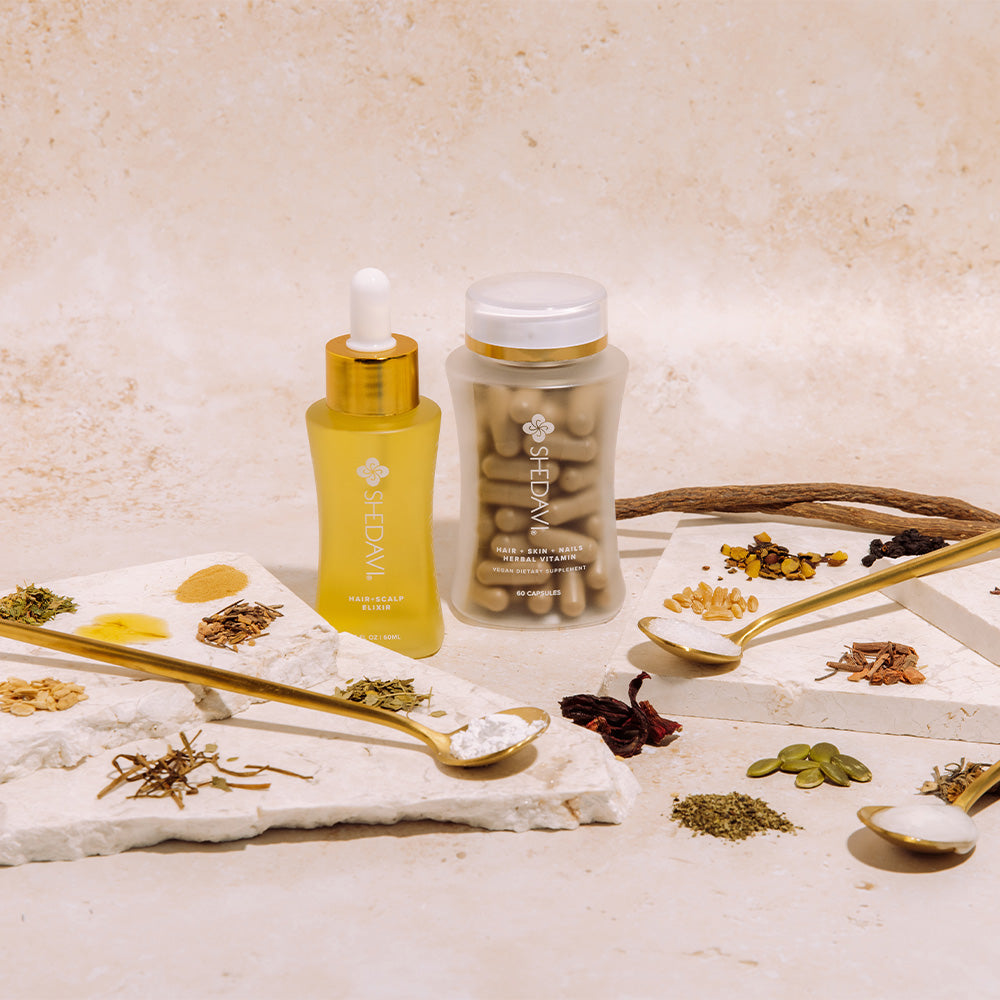 A hair elixir, vitamin capsules, and herbal ingredients displayed with spoons on a neutral background.